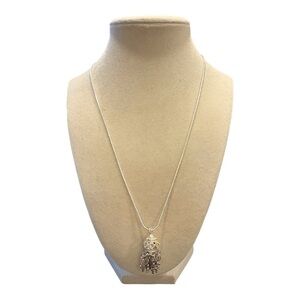 Silver chain with filagree dome pendant ringed in rhinestones w/cross drops. JB4